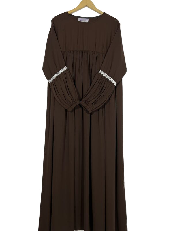 Brown dress with lace trim on sleeves and neckline, hanging against a white background