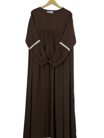 Brown dress with lace trim on sleeves and neckline, hanging against a white background