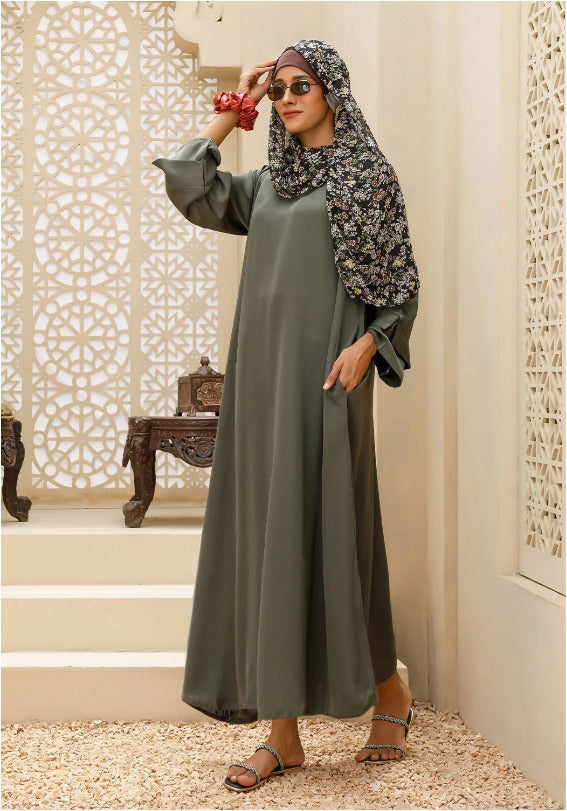Modest olive green abaya paired with hijab for Gulf fashion