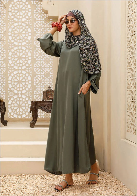 Modest olive green abaya paired with hijab for Gulf fashion